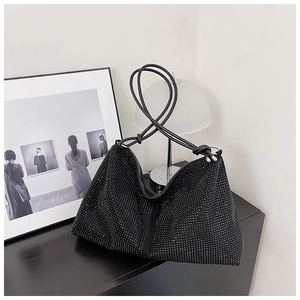 Close-up of a black rhinestone hobo bag featuring a knot handle and sparkling crystals