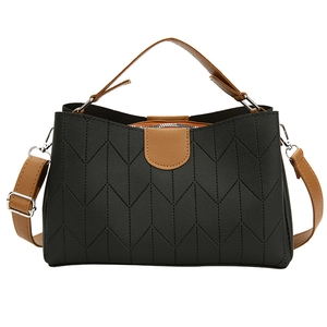 Minimalist black tote bag with V-quilted texture and brown handles for women