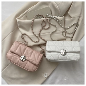 Detail of quilted chain shoulder bags in pink and white with silver twist locks