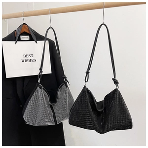Sparkling rhinestone hobo bag detail in black and silver gradient with leather strap