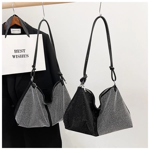 Detail of knot shoulder straps and rhinestone sparkling texture on elegant tote bags