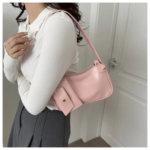 Close-up of pink shoulder bag with square pocket and golden button detail