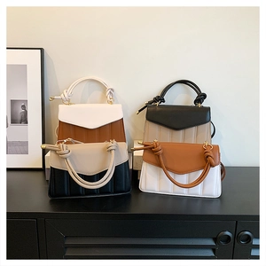 Detailed close-up of quilted color-block crossbody bags with stylish knotted handles