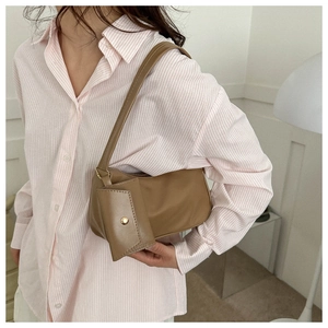 Detailed view of brown faux leather hobo bag with matching mini coin purse and chain