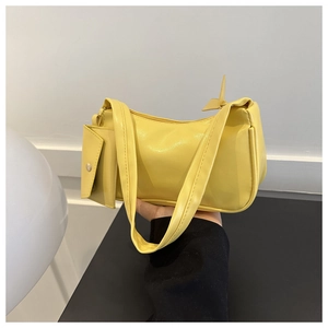 Detail of a lemon yellow baguette bag with a matching mini flip cover coin purse