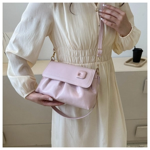 Détail du sac bandoulière froncé rose clair avec sangle réglable sur robe