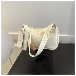 White baguette shoulder bag with small coin purse and golden zipper closure in detail
