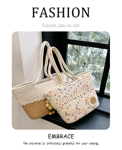 Detail of hollow woven cotton shoulder bags with color contrast and floral charm