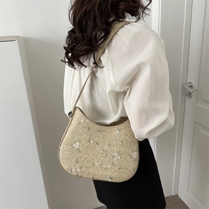 Straw shoulder bucket bag with floral embroidery and slim leather straps for summer
