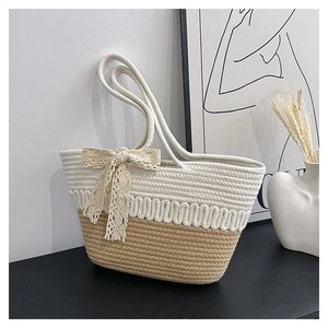 Detailed close-up of woven tote bag with lace bow and bicolor wavy knit texture