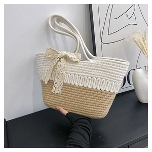 Close-up of woven tote bag with cream-khaki rope texture and delicate lace bow detail