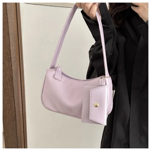 Detail view of lavender baguette bag featuring a detachable mini envelope coin purse charm