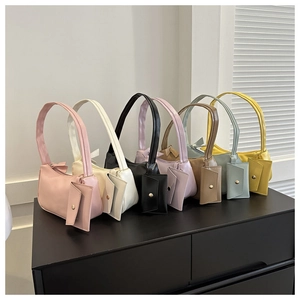 Detailed view of colorful minimalist faux leather underarm bags with matching coin pouches