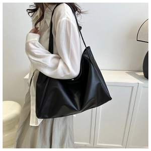 Minimalist black PU leather hobo tote bag styled with a casual white linen shirt
