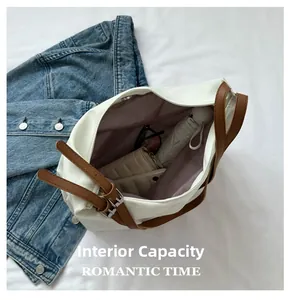 Spacious interior of white tote bag showing storage for phone wallet and umbrella