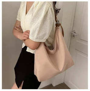 Detailed side view of the large capacity nude Oxford tote bag with adjustable strap