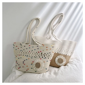 Detailed close-up of woven cotton rope beach tote bags with large floral accents