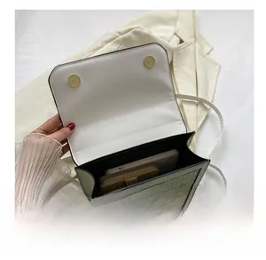 Interior view showing the capacity of the mint green crossbody bag with phone and wallet