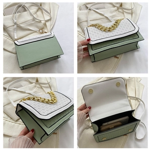 Detail view of mint green square bag showing woven texture, gold chain and spacious interior