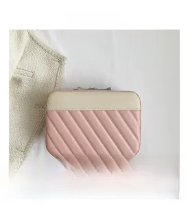 Detailed view of the quilted stitching and pink faux leather on the travel makeup case