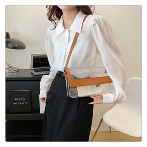 Détail du sac bandoulière transparent en PVC avec bordure en cuir marron sur mannequin