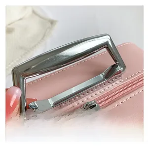 Pink quilted leather makeup box detail featuring silver metal handle and floral zipper pulls