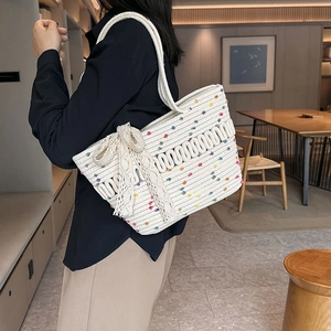 Large woven tote bag in white with colorful dots and a decorative lace bow