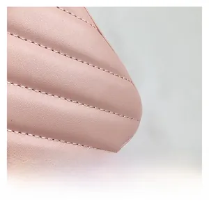 Detailed close-up of pink leather texture with elegant V-shaped quilted stitching