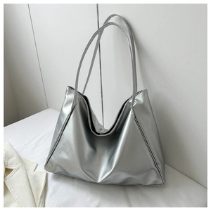 Detail view of the metallic silver tote bag with shiny PU leather and soft texture