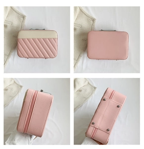 Detailed views of pink quilted vanity case showing metal feet and textured faux leather