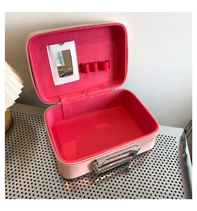 Pink quilted leather makeup box interior with mirror and soft red velvet lining