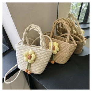 Close-up of three woven bucket bags with sunflower accents and decorative tassels