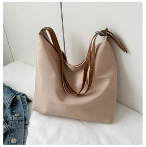 Detail of the pink nylon hobo bag with adjustable brown leather shoulder straps