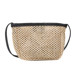 Straw shoulder bucket bag in beige with black leather trim and strap on white background
