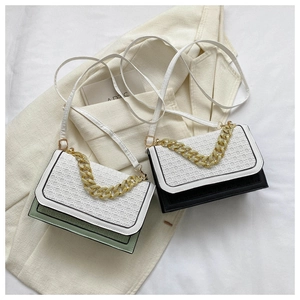 Detail of woven texture flap bags with chunky gold chain decoration and color-block design