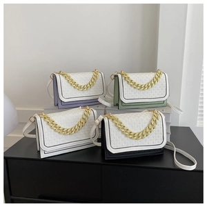Detail showing gold link chain and CK embossed texture on multicolored crossbody bags