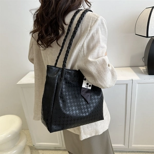 Minimalist black tote bag with houndstooth texture and stylish woven handle for women