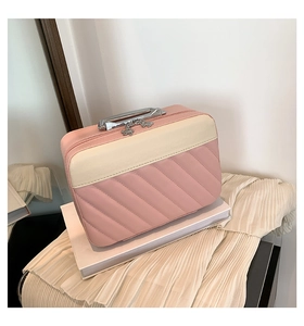 Detailed quilted texture and elegant flower zipper on pink and beige makeup bag