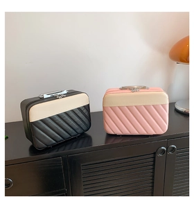 Close-up of quilted PU leather cosmetic cases in black and pink with metal handles