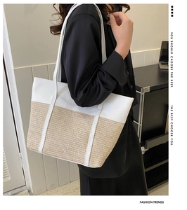 Detail view of large tote bag with white PU leather and straw patchwork design