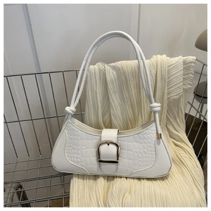 Détail du sac sous le bras en cuir blanc embossé croco avec boucle dorée et nœuds