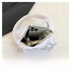 Interior view of white quilted crossbody bag showing spacious storage for daily items