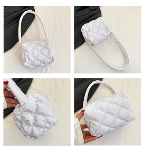 Detailed views of a white quilted nylon puffer bag featuring soft padding and gold zipper
