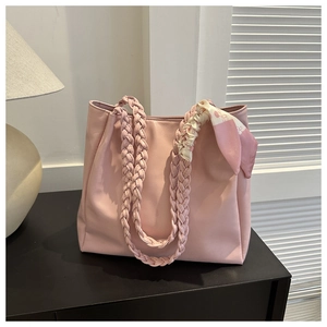 Pink faux leather tote bag with woven handles and decorative floral silk scarf detail