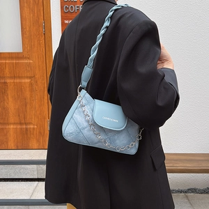 Light blue denim patchwork crossbody bag with braided strap and flower metal chain