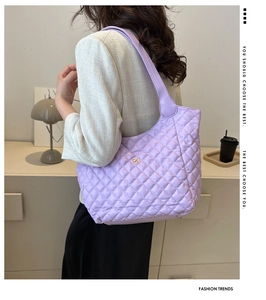 Detail of lavender quilted tote bag with gold floral clasp and rhombus stitching pattern
