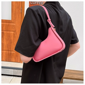 Pink leather hobo bag with a stylish asymmetrical design and sleek metal hardware detail