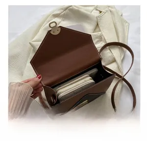 Interior view showing the large capacity of the brown flap crossbody bag with phone