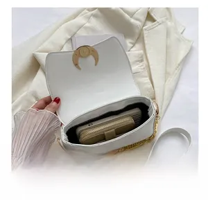 Internal view of white faux crocodile leather shoulder bag showing storage capacity