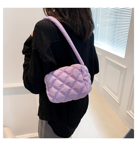 Close-up of lavender quilted nylon shoulder bag showing puffy texture and stitching